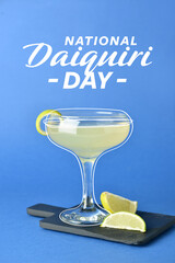Glass of tasty cocktail on color background. National Daiquiri Day