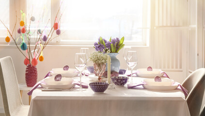 Interior of room with table set for Easter celebration near window
