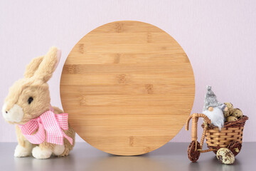 Wood round sign easter mockup with gnome, stuffed toy bunny and easter eggs. Blank round sign in...
