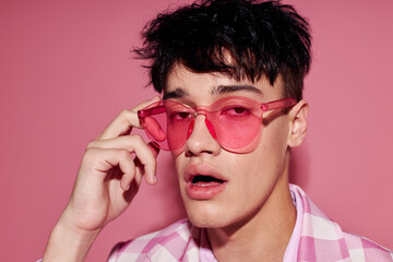 portrait of a young man self confidence pink plaid blazer fashion posing pink background unaltered