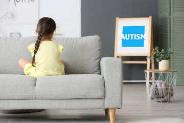 Sad little girl with autistic disorder at home, back view. World Autism Awareness day