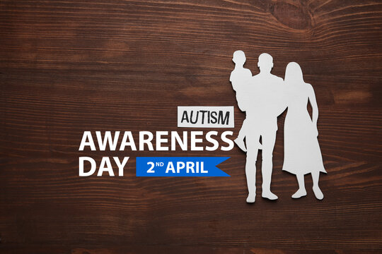 Figure of family on wooden background. World Autism Awareness day