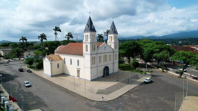 Aerial view around the Our Lady of Grace cathedral in Sao Tome - orbit, drone shot