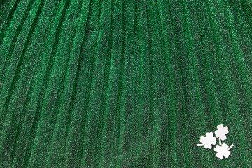 Paper clover St. Patrick's day on green sparkle background.