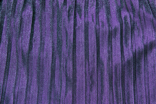 Purple violet sparkle festive pleated shiny background.
