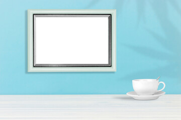 Poster template. Photo frame on wooden table with coffee cup