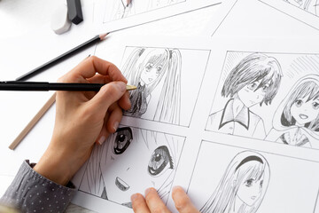 Manga style. The artist draws sketches of anime comics. Storyboard of characters on paper. - 487957687