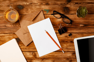 Letters and Office Supplies on Table Desk. Top View