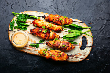 Chicken skewers with peanut sauce.