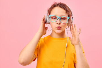 funny girl yellow t-shirt headphones entertainment music fun pink background unaltered