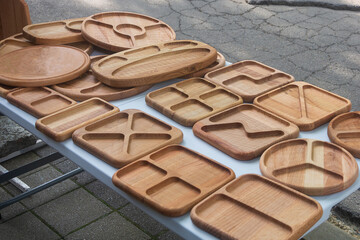 Handmade wooden plates in a market showcase. Eco dishes. Selective focus