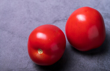 Two juicy red tomatoes on the table. - 487959483