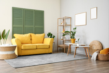 Interior of modern living room with yellow sofa, coffee tables and shelving unit