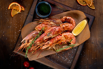 Langoustine shrimp on a wooden background with spices