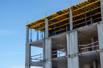 Construction site background. Hoisting cranes and new multi-storey buildings. Industrial background. brick building.