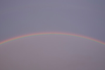 a colorful rainbow in a gray sky