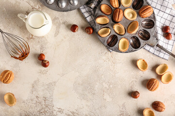 Walnut cookie mold maker and jug with milk on light background
