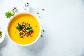 Traditional pumpkin soup with seeds and parsley