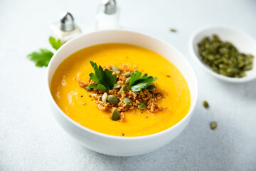 Traditional pumpkin soup with seeds and parsley