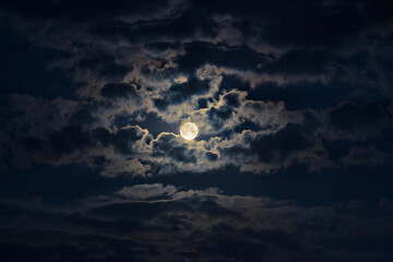 Full moon close-up in a cloudy sky