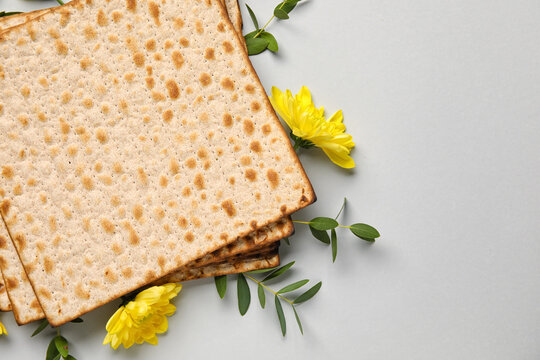 Jewish flatbread with flowers on light background