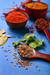 Aromatic spices on blue background, closeup
