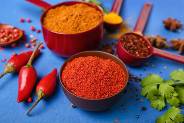 Aromatic spices on blue background, closeup