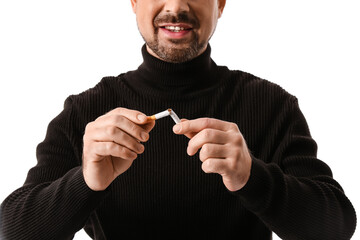 Man with broken cigarette on white background. Concept of refusing from bad habit