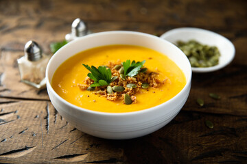Traditional pumpkin soup with seeds and parsley
