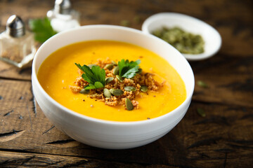 Traditional pumpkin soup with seeds and parsley