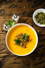 Traditional pumpkin soup with seeds and parsley
