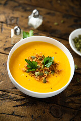 Traditional pumpkin soup with seeds and parsley