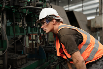 Engineer, foreman hard work with machine at factory	