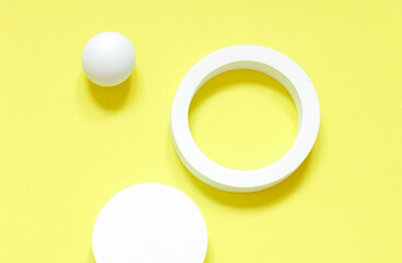 White round geometrical shapes on the brigth yellow background. Minimalistic abstact concept composition.	