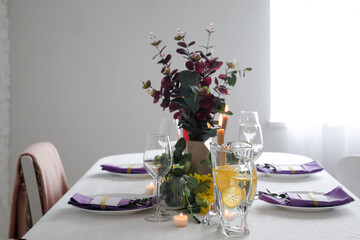 Dining table with beautiful setting and floral decor
