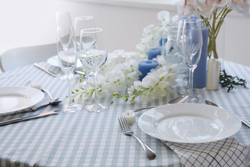 Dining table with beautiful setting and flowers