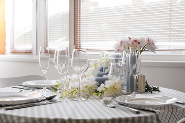 Dining table with beautiful setting and flowers