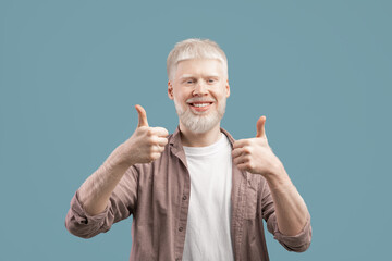 Like. Overjoyed albino man gesturing thumbs up to camera, approving or recommending something over...