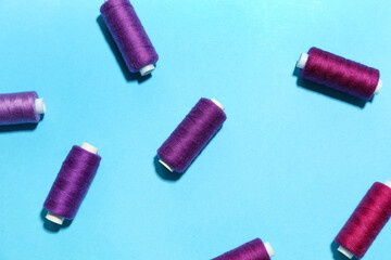 Different sewing threads on blue background