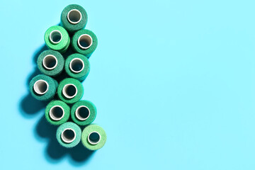 Beautiful sewing threads on color background