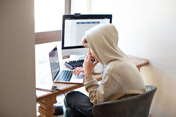 Teenager programmer coding on laptop and computer. Education or playing online game at home, teenage free time with gadget