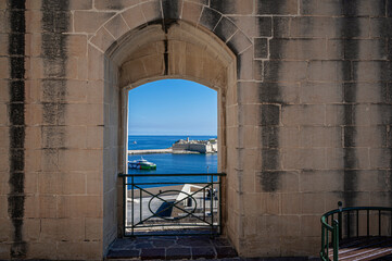View of Mediterranean sea from window in city wall in Valletta, Malta. View from lower barrakka gardens.