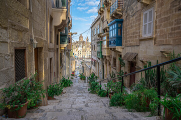 Fototapeta na wymiar Narrow street with stairs in Valletta, Malta