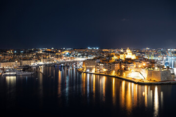View of Three cities in Malta at night. Photo taken from Valletta. The Grand Harbour illuminated at night.