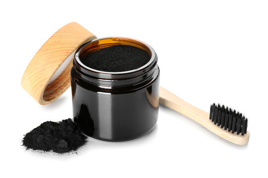 Jar with activated charcoal tooth powder and toothbrush on white background