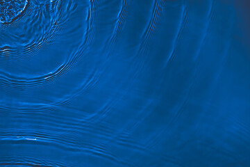Transparent dark blue clear water surface texture with ripples, splashes and bubbles. Abstract...