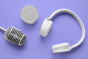 Wireless portable speaker, microphone and headphones on color background