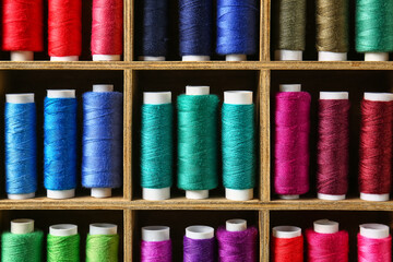 Shelves with different sewing threads, closeup