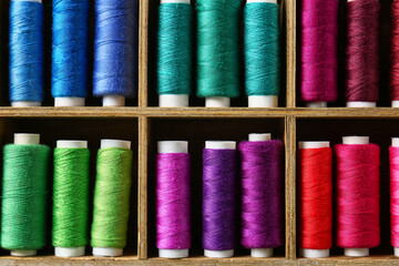 Shelves with different sewing threads, closeup