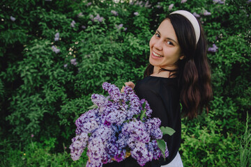 beautiful woman posing with lilac flowers